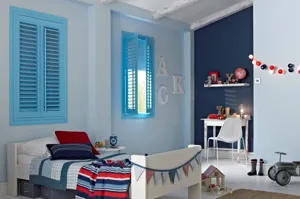 blue shutters fitted to windows in a kids bedroom