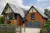 Large house with attached garage and second storey block with two grey sectional garage doors.