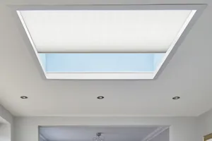 Close up of roof lantern window dressed in white duette blind partially open.