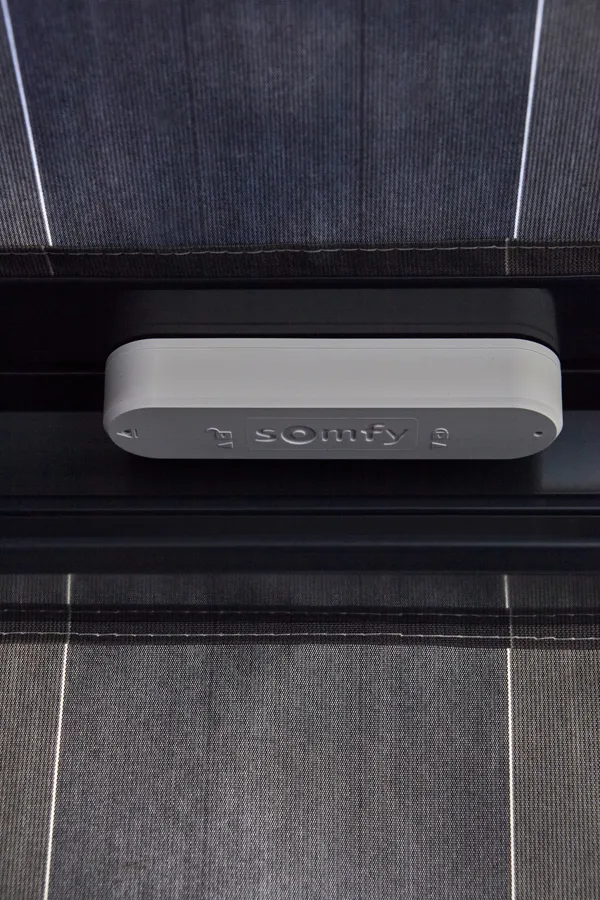 Underside of an awning showing a somfy power box.