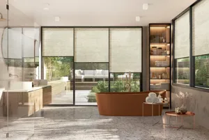 Large bathroom with floor to ceiling glass windows and doors to far side, large windows to right and pale beige marble to floor and walls, with copper bath and walk-in shower and windows and doors dressed in pale oatmeal duette blinds.