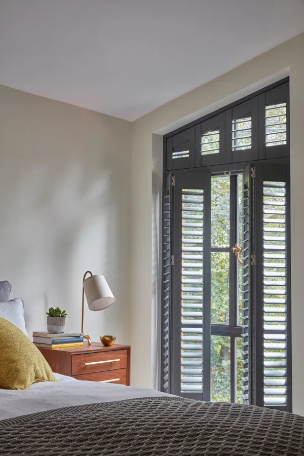 opened grey shutters on a slanted window in the Tebbutts bedroom